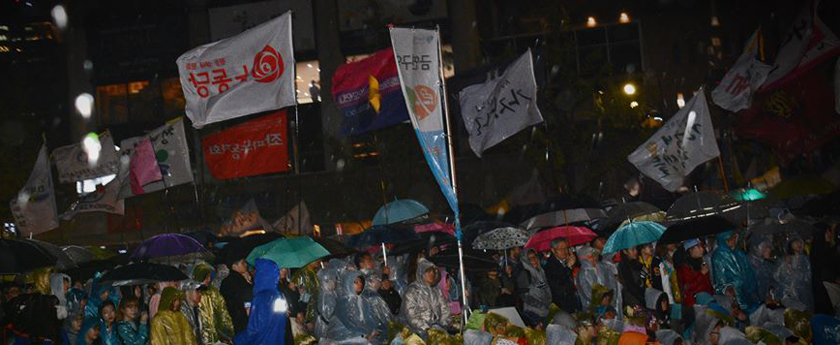 Protest vigil in the pouring rain at Gwanghwamun in Seoul.