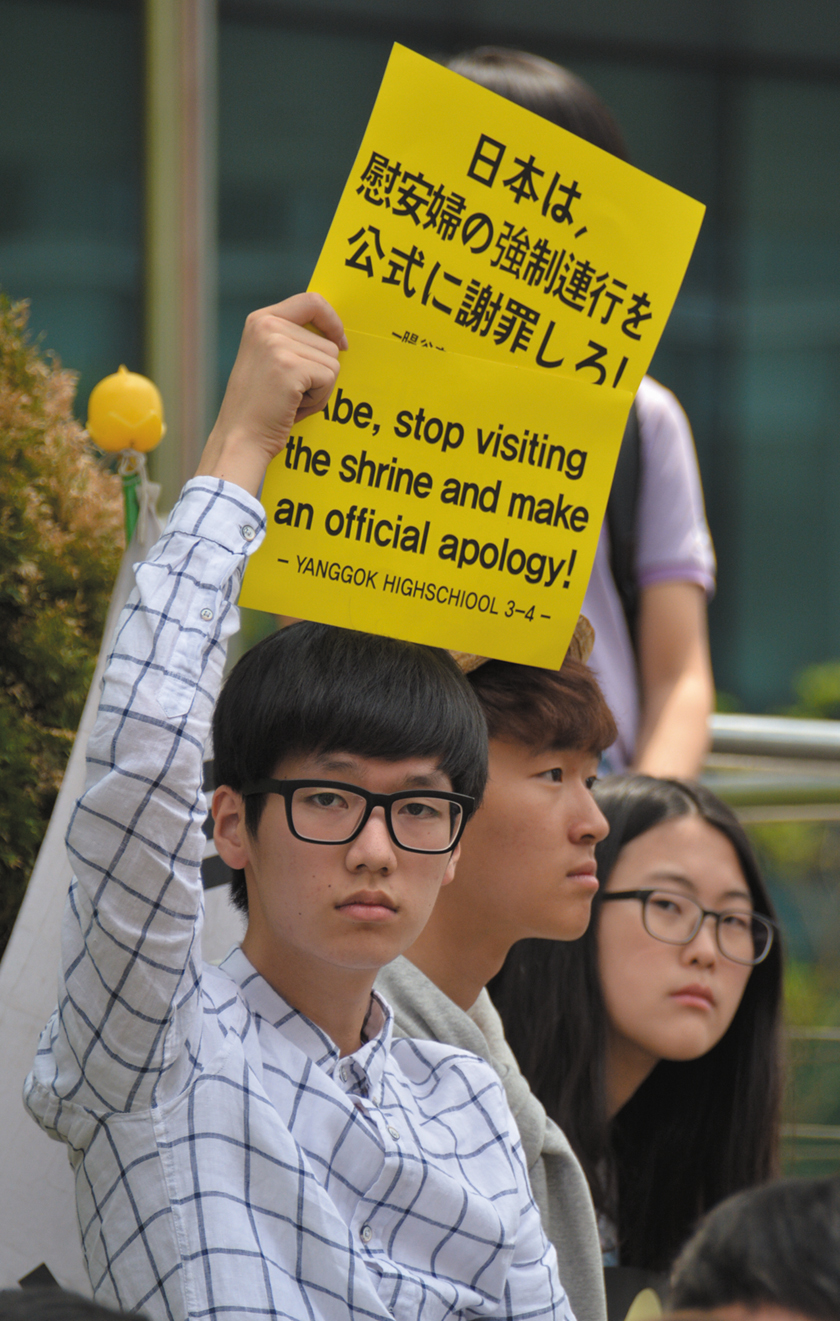 Students participate in one of the comfort women weekly vigils in front of the Japanese embassy in Seoul.