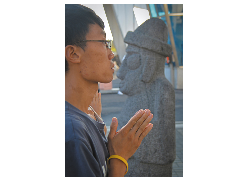 100 Bows start each day at the entrance to the main gate of the naval base in Gangjeong, Jeju island, South Korea