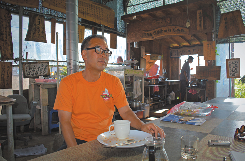 Catholic priest, Father Sunghwan Kim at the community kitchen near the naval base, Gangjeong, Jeju island, South Korea.