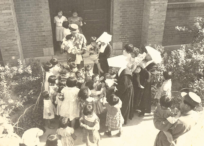 American GI's visit an orphanage near Bupyeong, South Korea