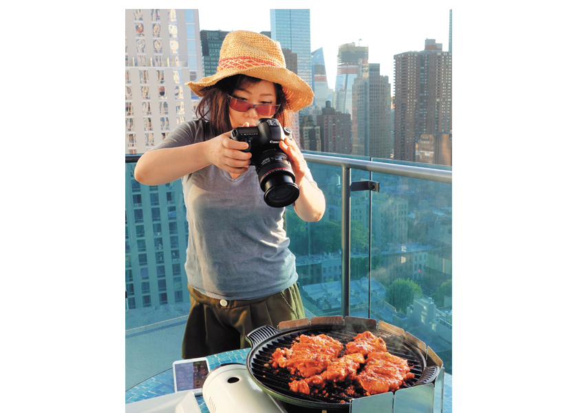 Maangchi (Emily Kim) photographing her culinary creations.